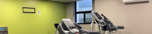 Cedarwoods Tower fitness facility with treadmill and elliptical machine in Kitchener, ON