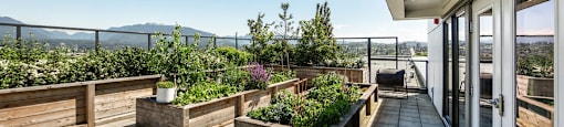 A patio with a view of the mountains and a fence at 388 Kaslo East Village.