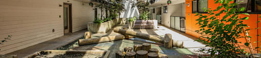 A view of a courtyard with a fountain and trees at 388 Kaslo East Village.
