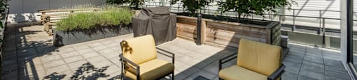 A patio with a table, chairs and plants at 388 Kaslo East Village.