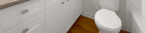 Kensington Apartments bathroom with large vanity with lots of storages and shaker-style cabinetry