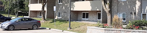 Kensington Apartments in Brockville showing suites with balconies at front of building
