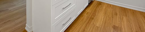Kensington Apartments in Brockville with white, shaker-style cabinetry, sink, stainless steel dishwasher and window