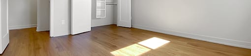Kensington Apartments primary bedroom from corner of room looking towards closet with built in storage