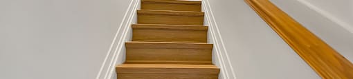 Kensington Apartments stairs with hard surface luxury vinyl plank floor leading to second floor
