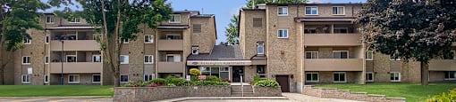 Front of Kensington Apartments in Brockville Ontario showing the main building entrance from the parking lot