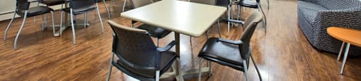 Laura Secord Apartments social room with tables and chairs and a tv in Niagara Falls, ON