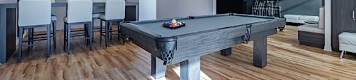Games room featuring billiards table and additional seating at La Voile Pointe-Claire apartments in Pointe-Claire, Quebec