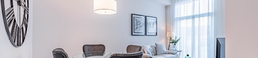 Dining room with luxury vinyl flooring and modern furnishing at La Voile Pointe-Claire apartments in Pointe-Clare, Quebec
