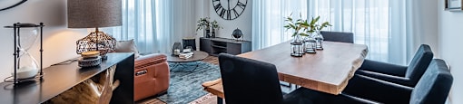 Brightly lit dining room with modern furnishings at La Voile Pointe-Claire apartments in Pointe-Claire, Quebec