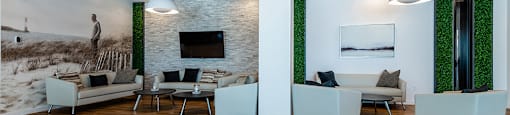 Relaxing social room with padded cube chairs at La Voile Pointe-Claire apartments in Point-Claire, Quebec