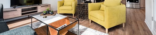 Open concept living room with view into kitchen at Le Saint-Laurent Apartments in Brossard