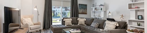 Large spacious living room with walk out patio at Le Saint-Laurent Apartments in Brossard