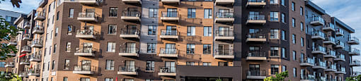 Exterior view of Le Saint-Laurent Apartments building 8035 showing front of building from grassy area