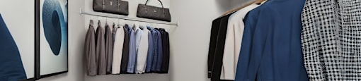 a closet filled with clothes and accessories and a mirror on the wall at Les Jardins Hauterives