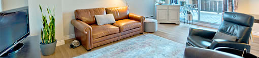 Les Jardins Hauterive in Sherbrooke, QC spacious living room with access to private balcony