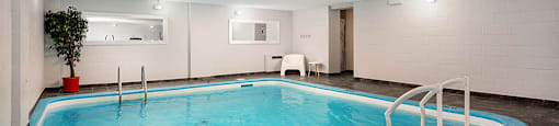 a swimming pool with a ladder in the middle of it