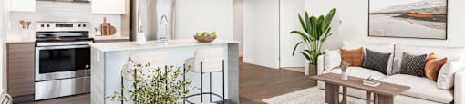 A modern living room with a wooden floor and a white sofa at 388 Kaslo East Village.