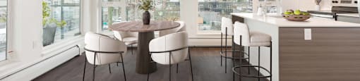 A modern kitchen with a dining table and chairs at 388 Kaslo East Village.