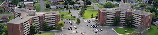 Exterior grounds, showing north side of building, and looking towards the St. Lawrence River, at Lorneville Apartments in Cornwall, ON