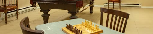 Games room, showing pool / billiard's table, dart board and chess board at Lorneville Apartments in Cornwall, ON