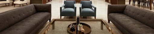 A modern living room with a dark grey sofa and a coffee table in the center.