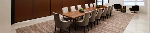 A conference room with a long table and chairs.