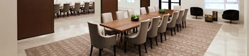 A conference room with a long table and chairs.