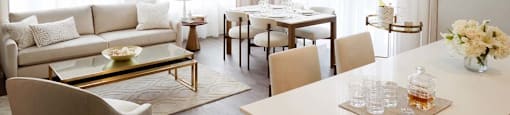 A modern living room with a dining table and chairs.