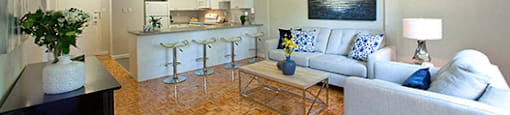 A living room with a white couch and a wooden floor.