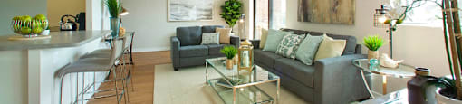 Millside Tower bright, open concept living room with view of kitchen in Milton, ON