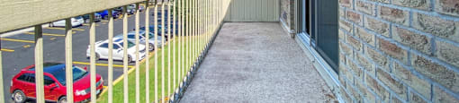 A private balcony overlooking the parking lot at Moira Apartments in Belleville, ON