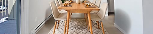 A dining room with a table at Moira Apartments in Belleville, ON