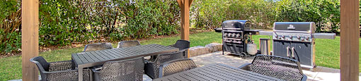BBQ area with dining seating located at Moira Apartments in Belleville, ON