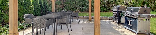 Gazebo and BBQ area with dining seating located at Moira Apartments in Belleville, ON