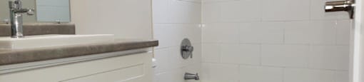 Refinished bathroom in an open concept suite at Moira Apartments in Belleville, ON.