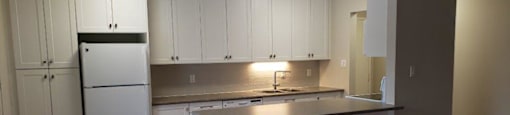 Refinished kitchen in an open concept layout at Moira Apartments in Belleville, ON.