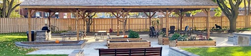 Large outdoor gazebo with BBQ and ample seating at Northgate Tower Apartments in Woodstock, ON