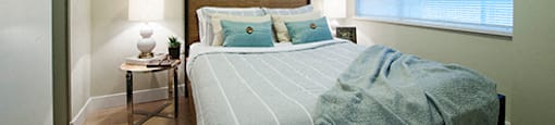 Bedroom with green blue blankets and light green walls