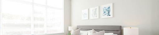 Bedroom with open blinds, allowing the sunlight to filter onto the bed
