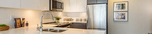 Full kitchen with ample lighting and view of the stairs