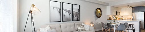 Living room with three paintings and a grey toned flooring