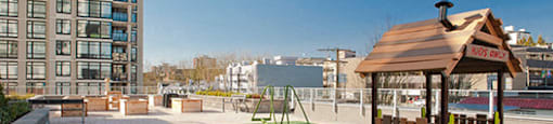 Novare's rooftop patio with a children's play set and synthetic grass