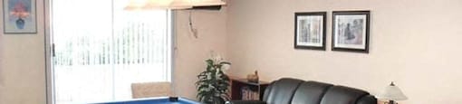 Pickering Towers social room with pool table and couch seating in Amherstburg, ON