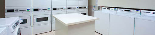 Edgehill Apartments in Barrie, ON Shared laundry space with rows of washers and dryers
