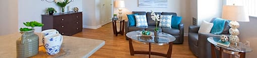 Edgehill Apartments in Barrie, ON modern living room with two couches and a round glass coffee table