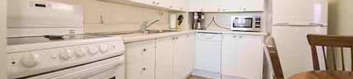 Prince William Apartments kitchen with white cabinetry in Bellville, ON
