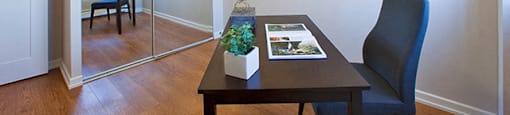 Mountain View Study room with a dark wood desk and chair. A mirrored door closet is on the left in Collingwood, ON