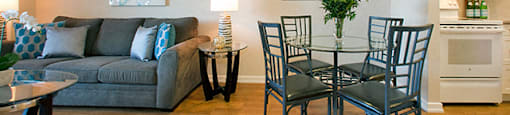 Mountain View Living room that connects to the dining room, a fan is on the ceiling and there is a table with four chairs around it near the entrance to the kitchen in Collingwood, ON