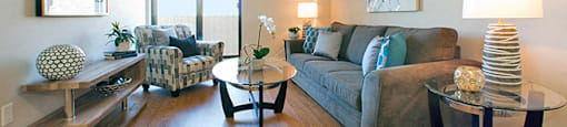 Mountain View Living room with a TV attached to the wall, a couch and an open, brightly lit space in Collingwood, ON